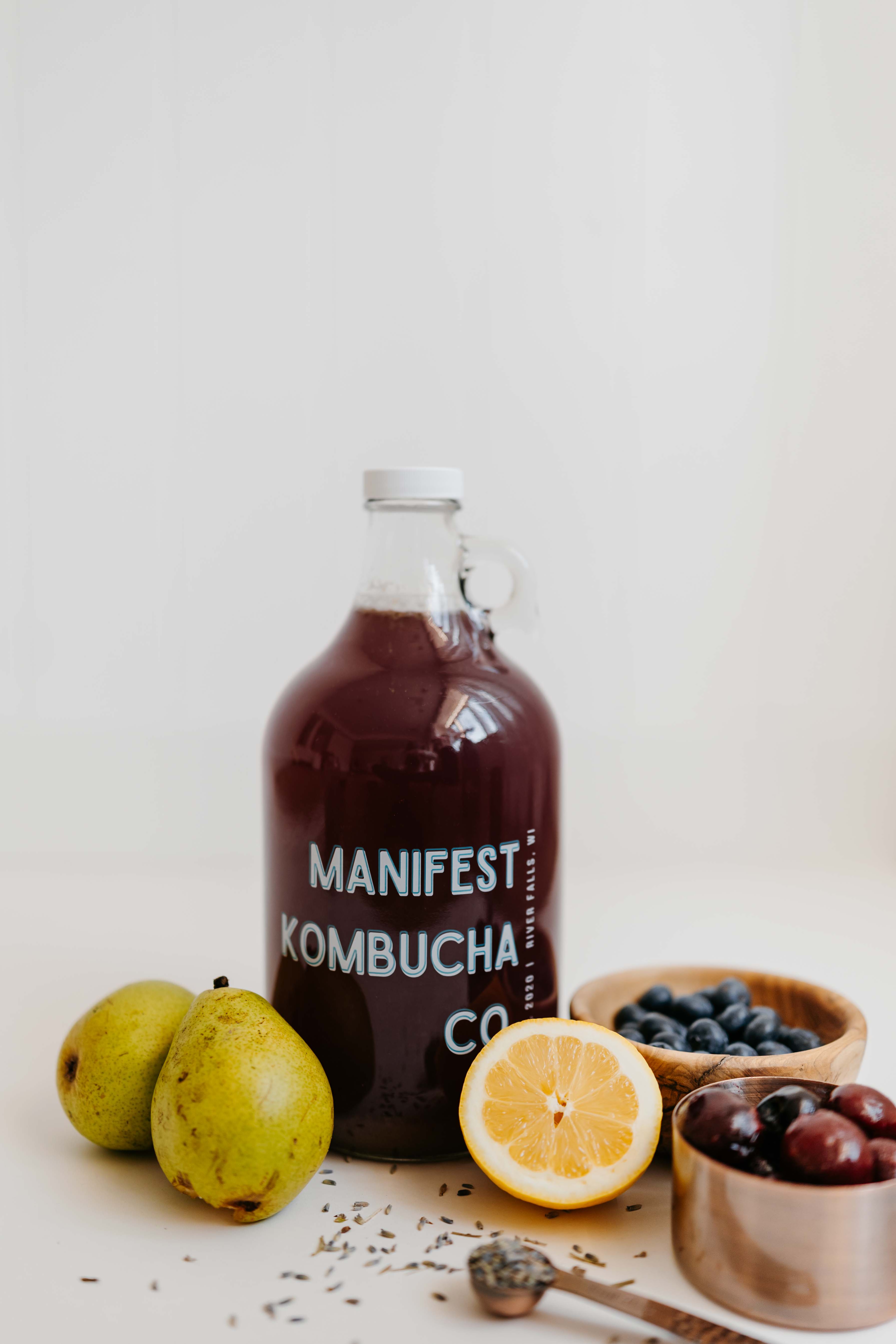 Finished bottle of Manifest Kombucha with pears, blueberries, and lemon